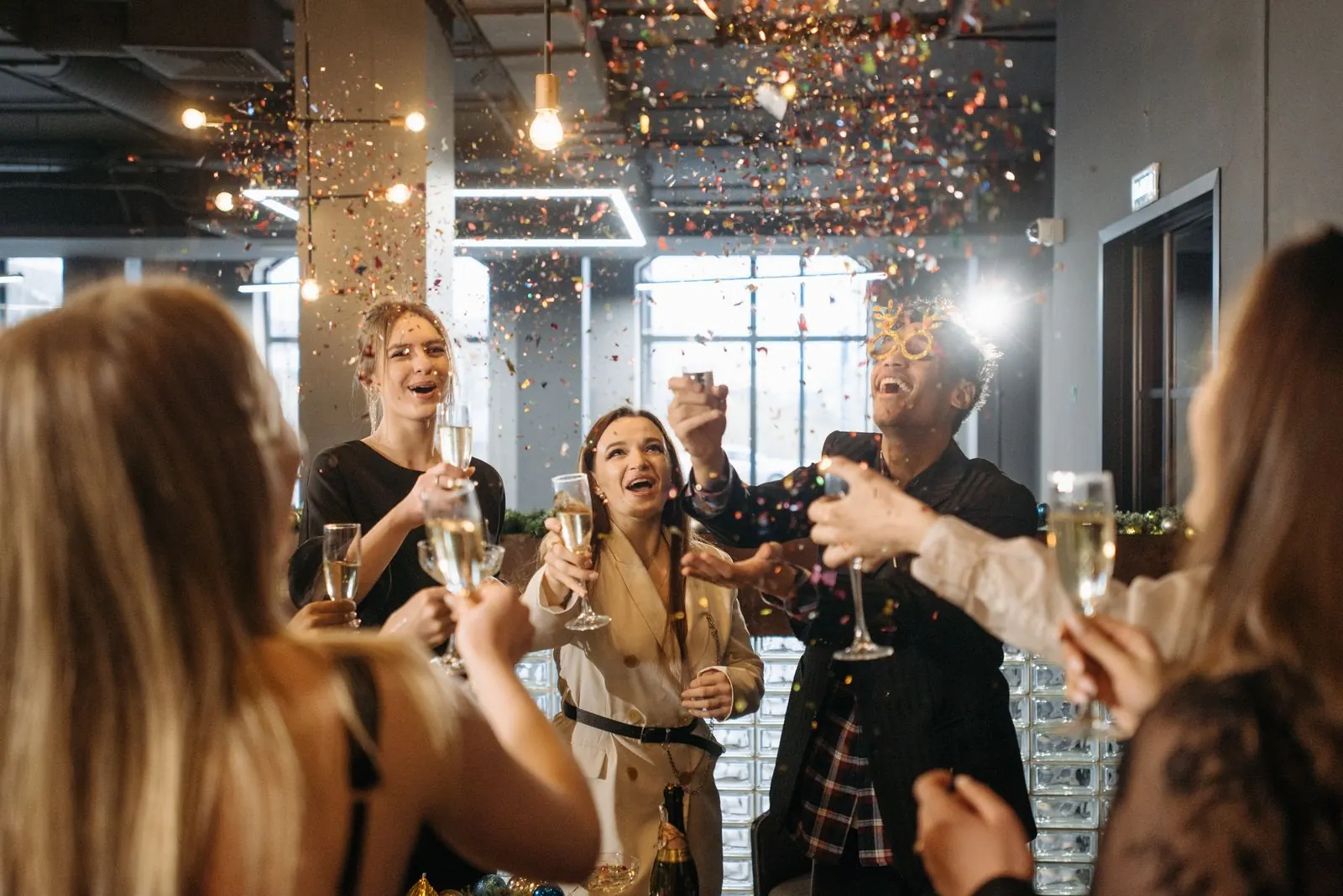Coworkers toasting at a corporate event with a photo booth