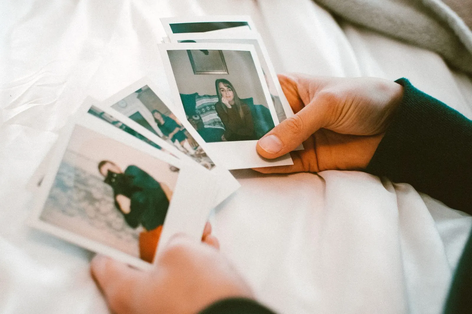 Hand holding instant photo booth prints