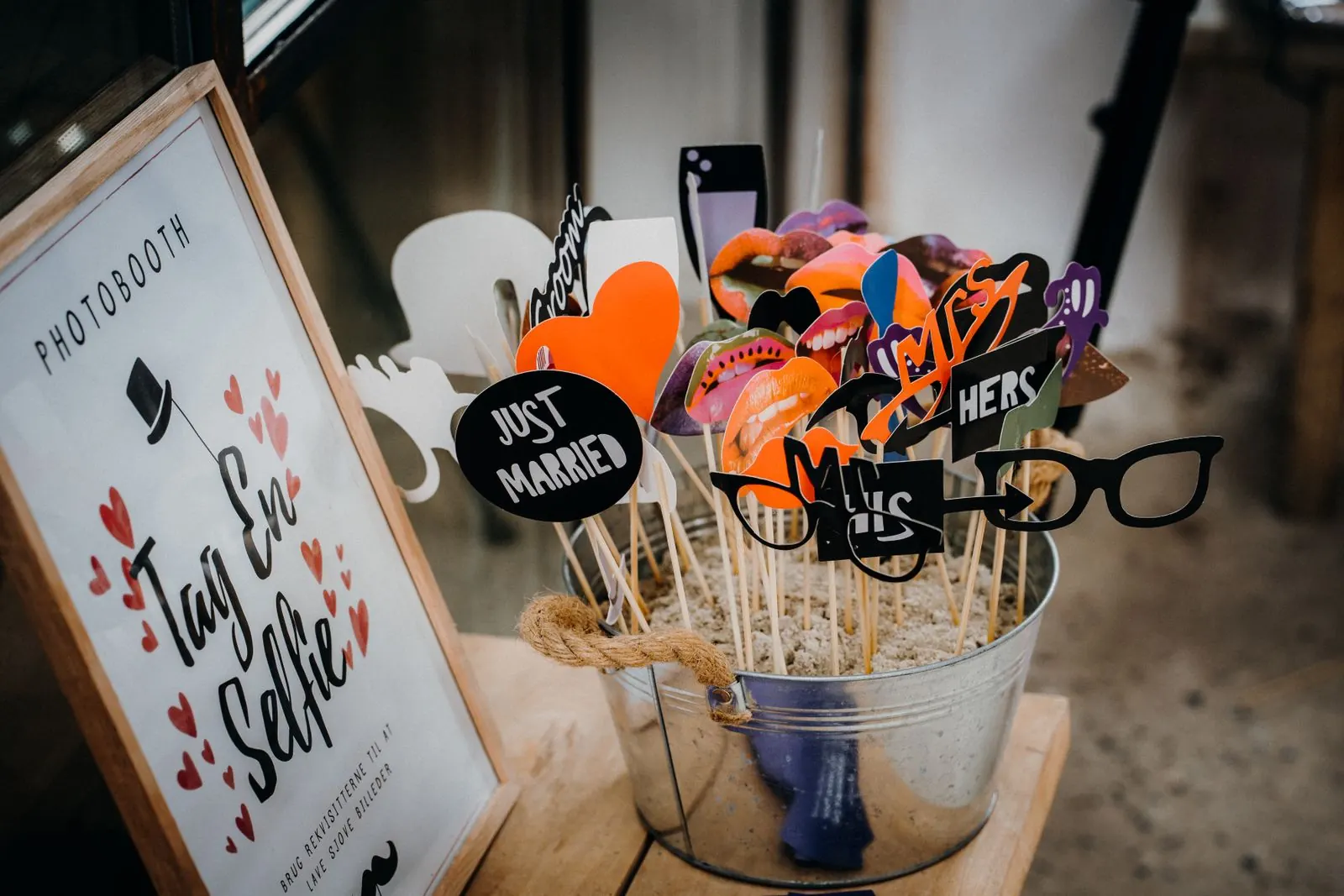 Bucket of wedding photo booth props including glasses and moustaches